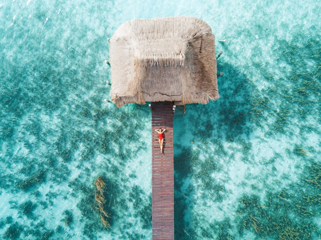 Bungalow sur pilotis au-dessus d'un lagon turquoise